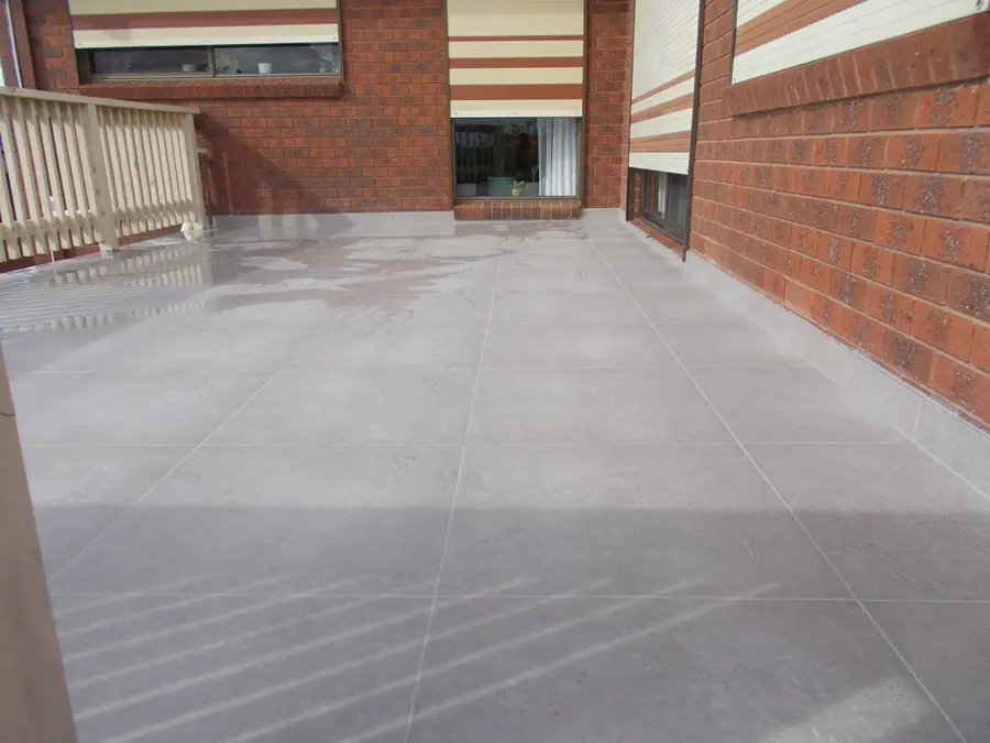 Pale grey courtyard tiles against red brick