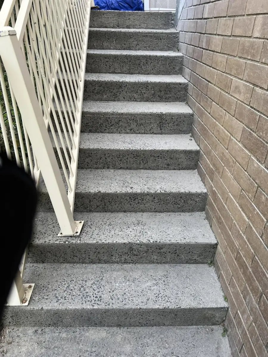 Outdoor staircase with speckled tile treads