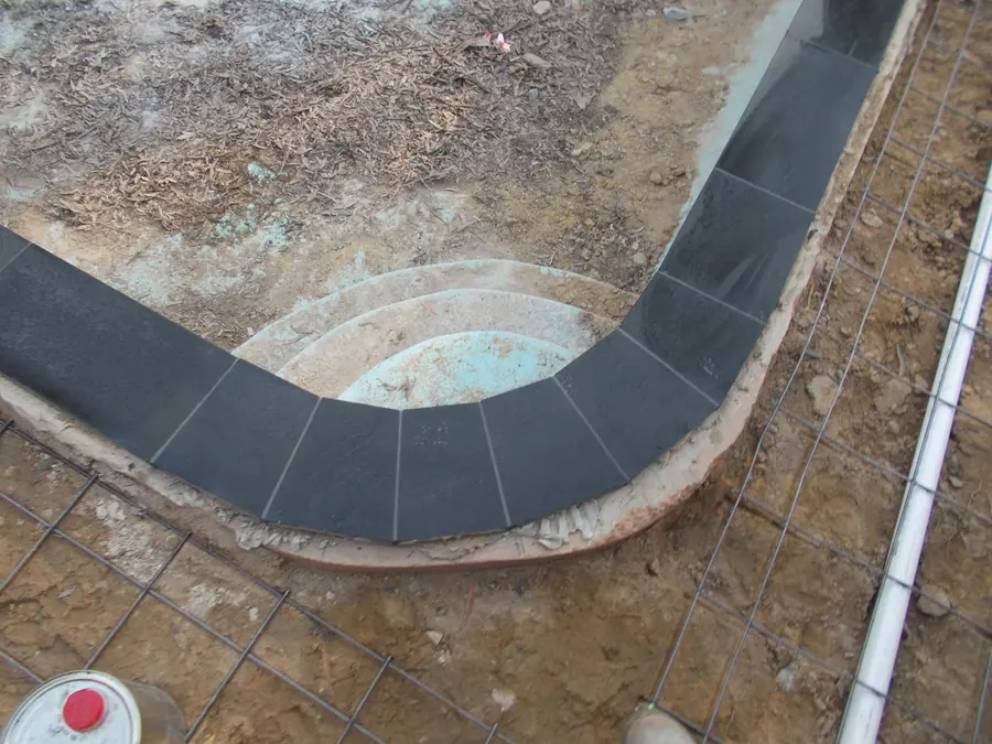 Pool surround being rebuilt with new stone coping
